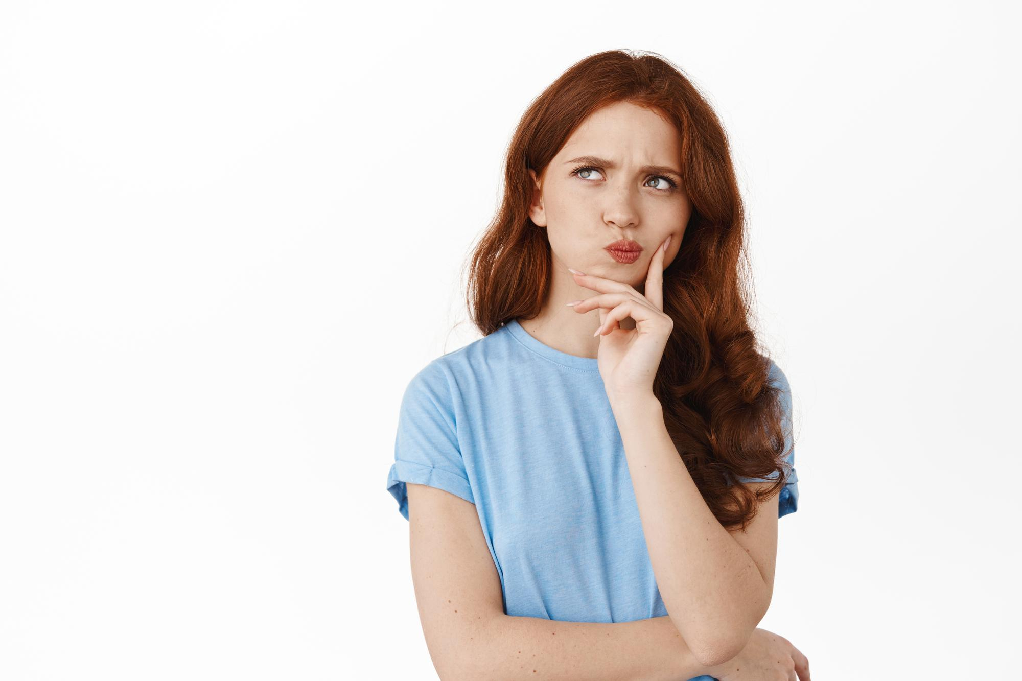 image-thoughtful-hesitant-girl-with-red-hair-making-decision-frowning-perplexed-thinking-touching-lip-pondering-standing-against-white-background